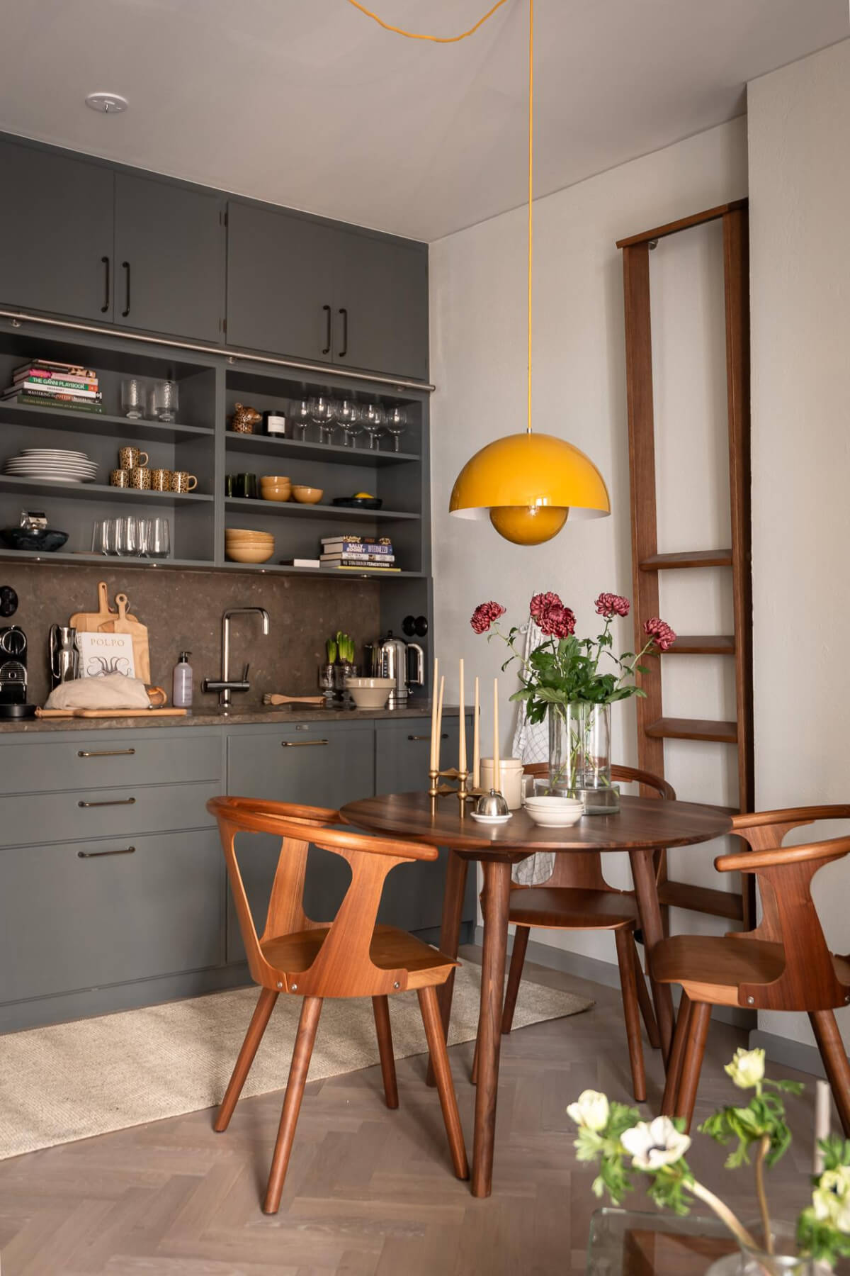 gray kitchen round wooden table yellow pendant