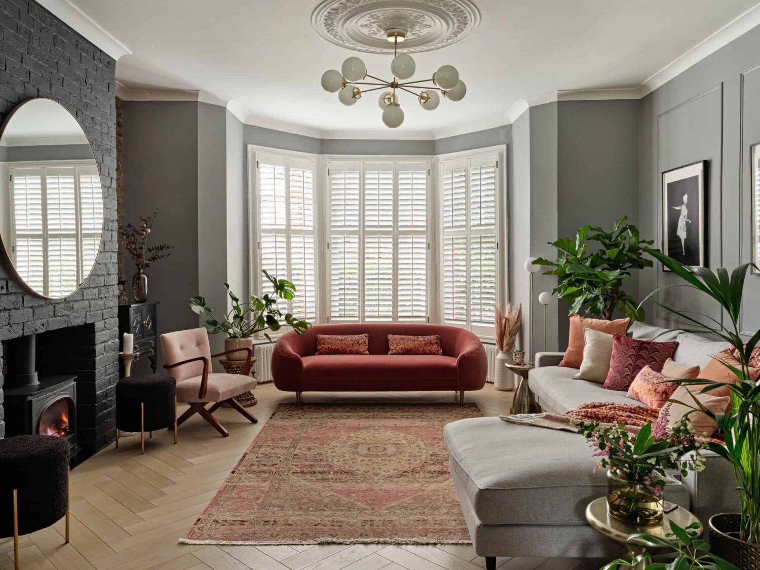 Pink & Gray Rooms in a Victorian Home with a Guest House 1 gray living room with bay window and painted brick fireplace nordroom