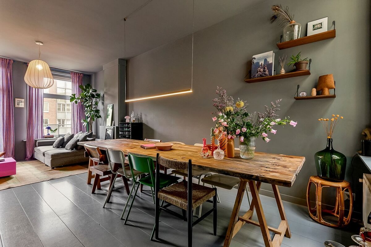 An Amsterdam Apartment with Surprising Bold Color Accents 5 gray living room with large wooden dining table