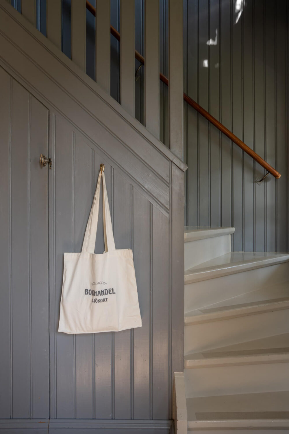 A Charming Historic Country House North of Stockholm 29 gray paneled staircase