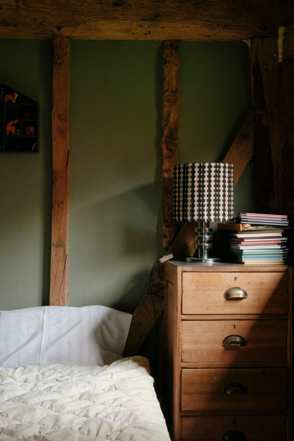 A Barn House with Vintage Decor and Exposed Beams 32 green bedroom with exposed beams