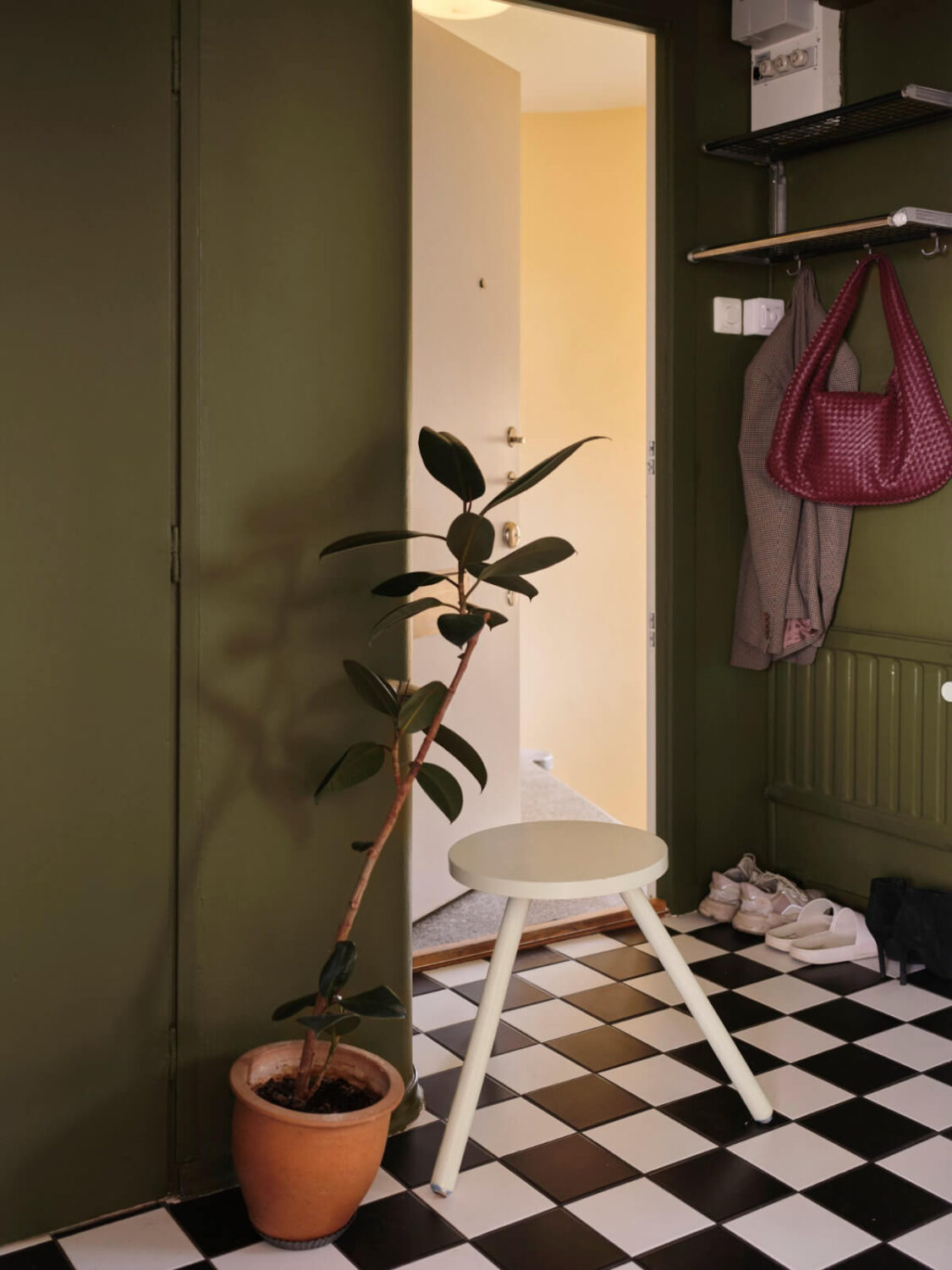 A 1940s Swedish Apartment with a Soft Yellow Kitchen 21 green hall black and white checkerboard floor A 1940s Swedish Apartment with a Soft Yellow Kitchen