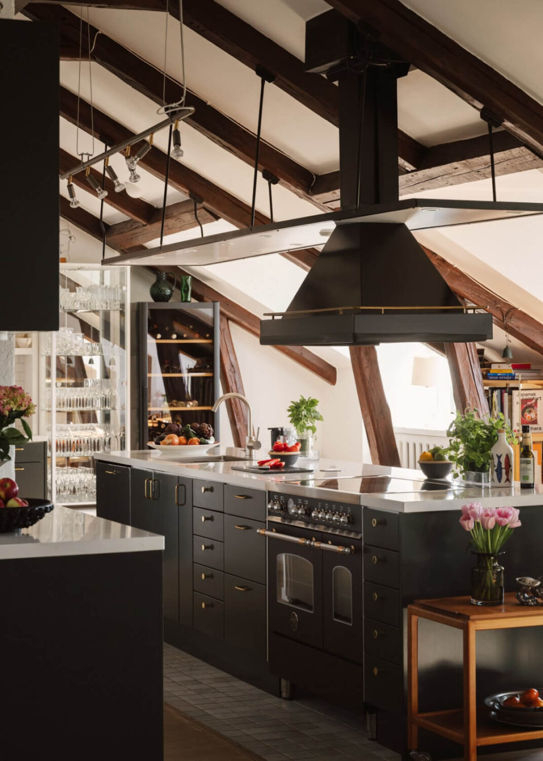Revisiting a Spectacular Stockholm Penthouse with Exposed Beams 11 green kitchen penthouse
