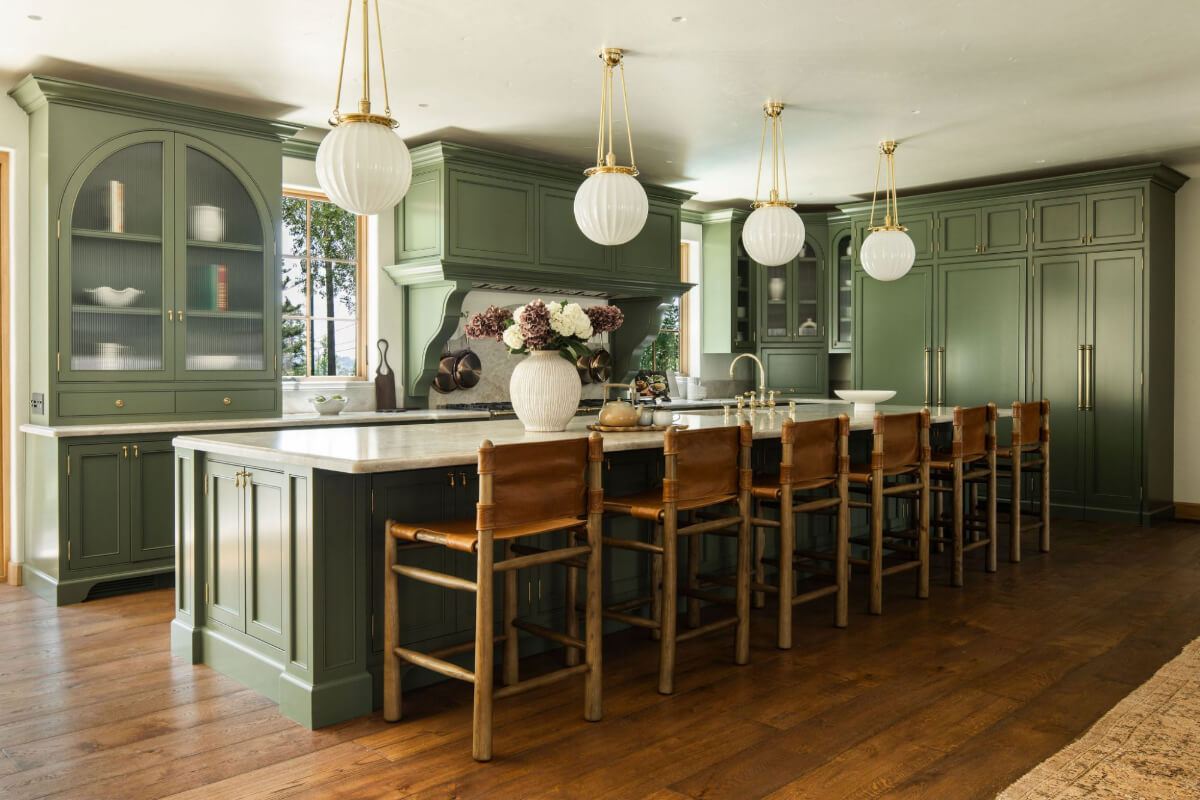 A Reimagined Spanish Colonial Revival Estate in Los Angeles 4 green kitchen with large island and stools