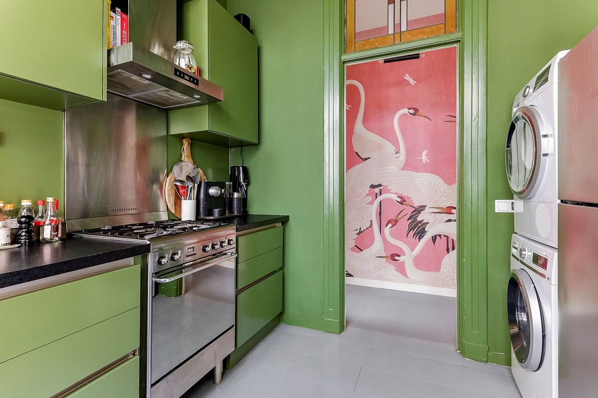 An Amsterdam Apartment with Surprising Bold Color Accents 10 green kitchen with washer dryer