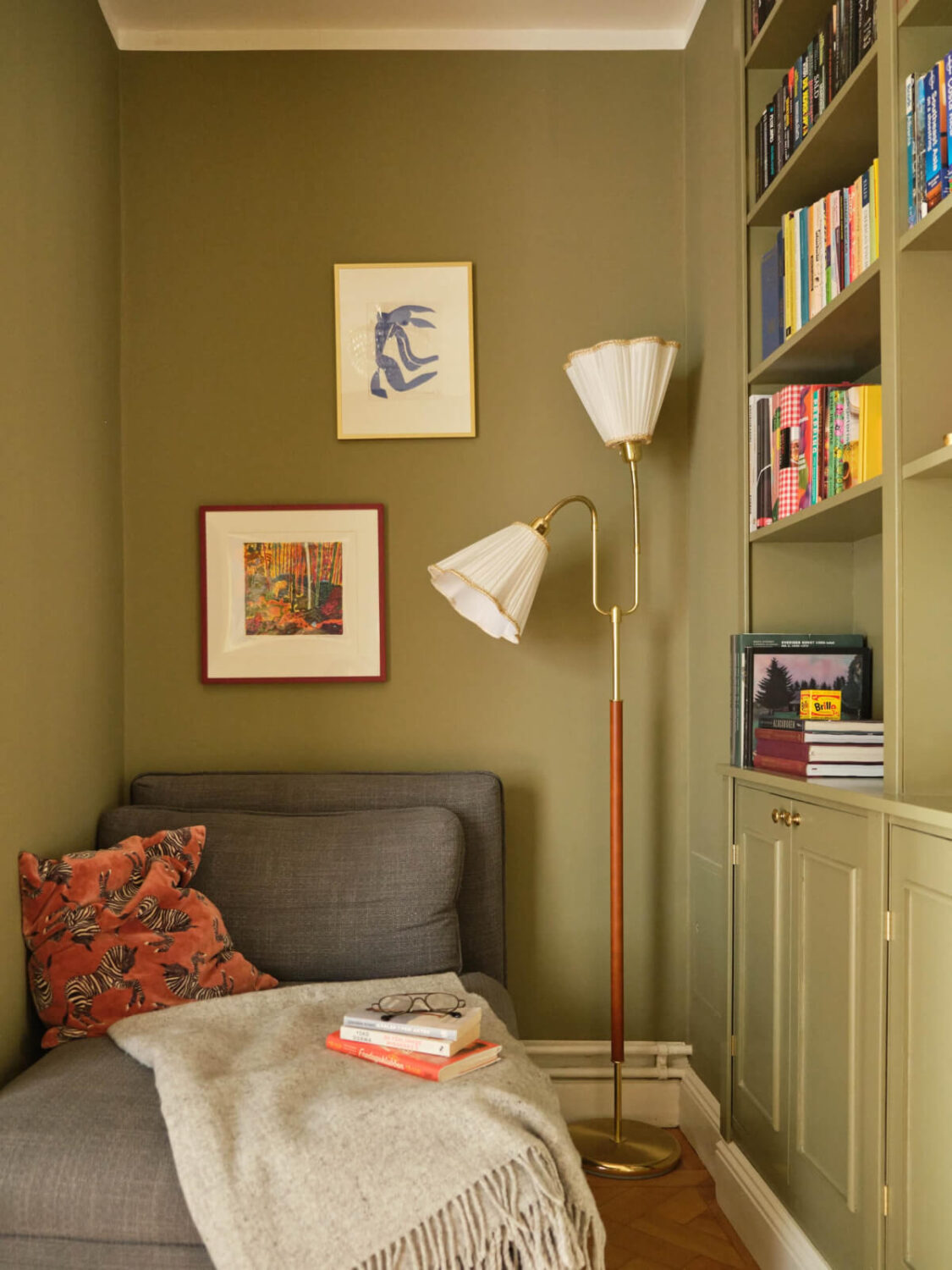 A Beautiful Color Palette and Historic Elements in a Stockholm Apartment 26 green reading nook with built-in bookshelves
