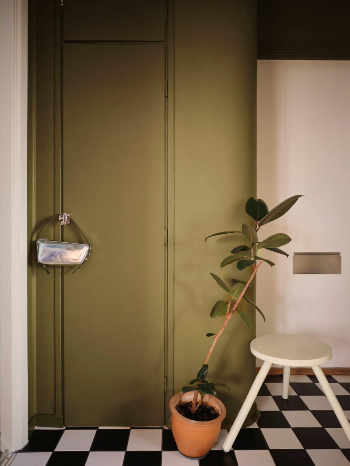 A 1940s Swedish Apartment with a Soft Yellow Kitchen 20 hall green built-in cabinets