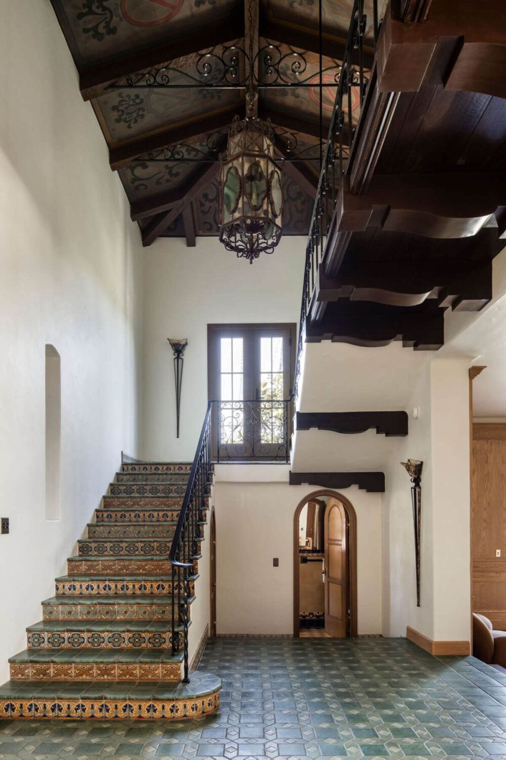A Reimagined Spanish Colonial Revival Estate in Los Angeles 8 hall ornate wooden ceiling tiled stairs
