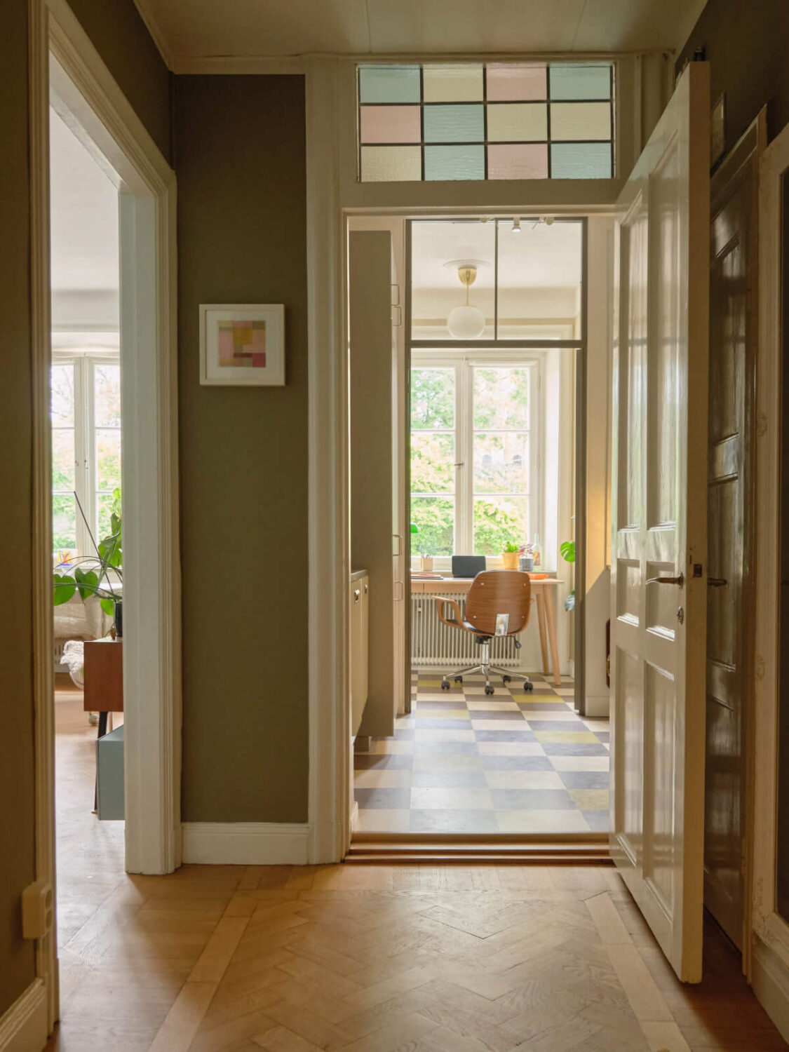 A Beautiful Color Palette and Historic Elements in a Stockholm Apartment 19 hall stained glass window