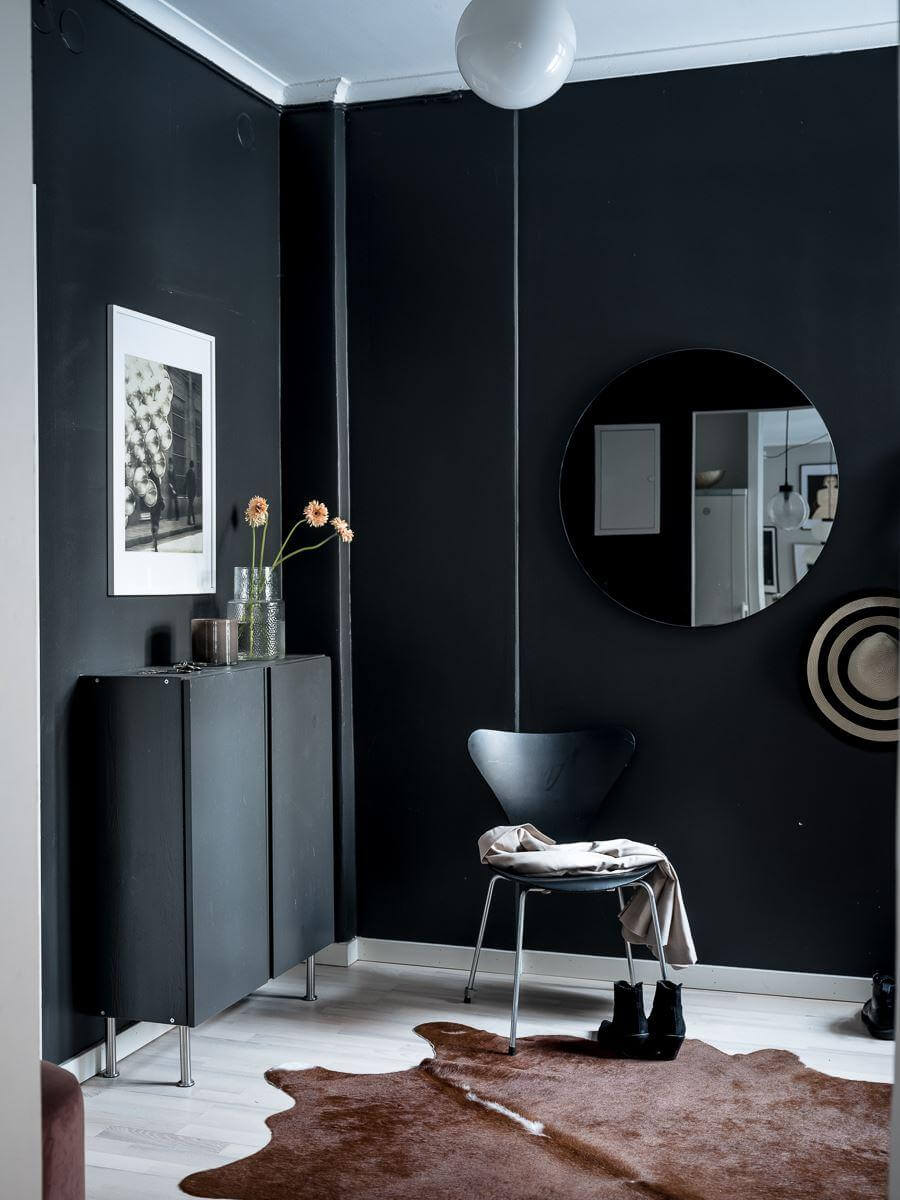 A Cozy Monochrome Gray Studio Apartment 20 hallway with black walls round mirror ikea ivar cabinets nordroom