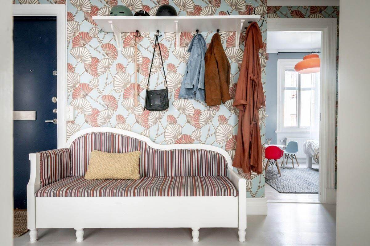 hallway with striped bench and wallpaper