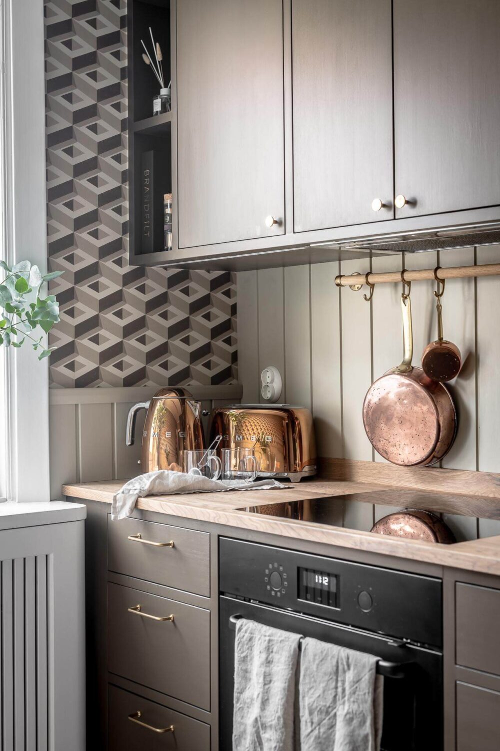 The Pros and Cons of a Wooden Kitchen Countertop 20 kitchen-detail-ikea-cabinets-brown-geometric-wallpaper-nordroom