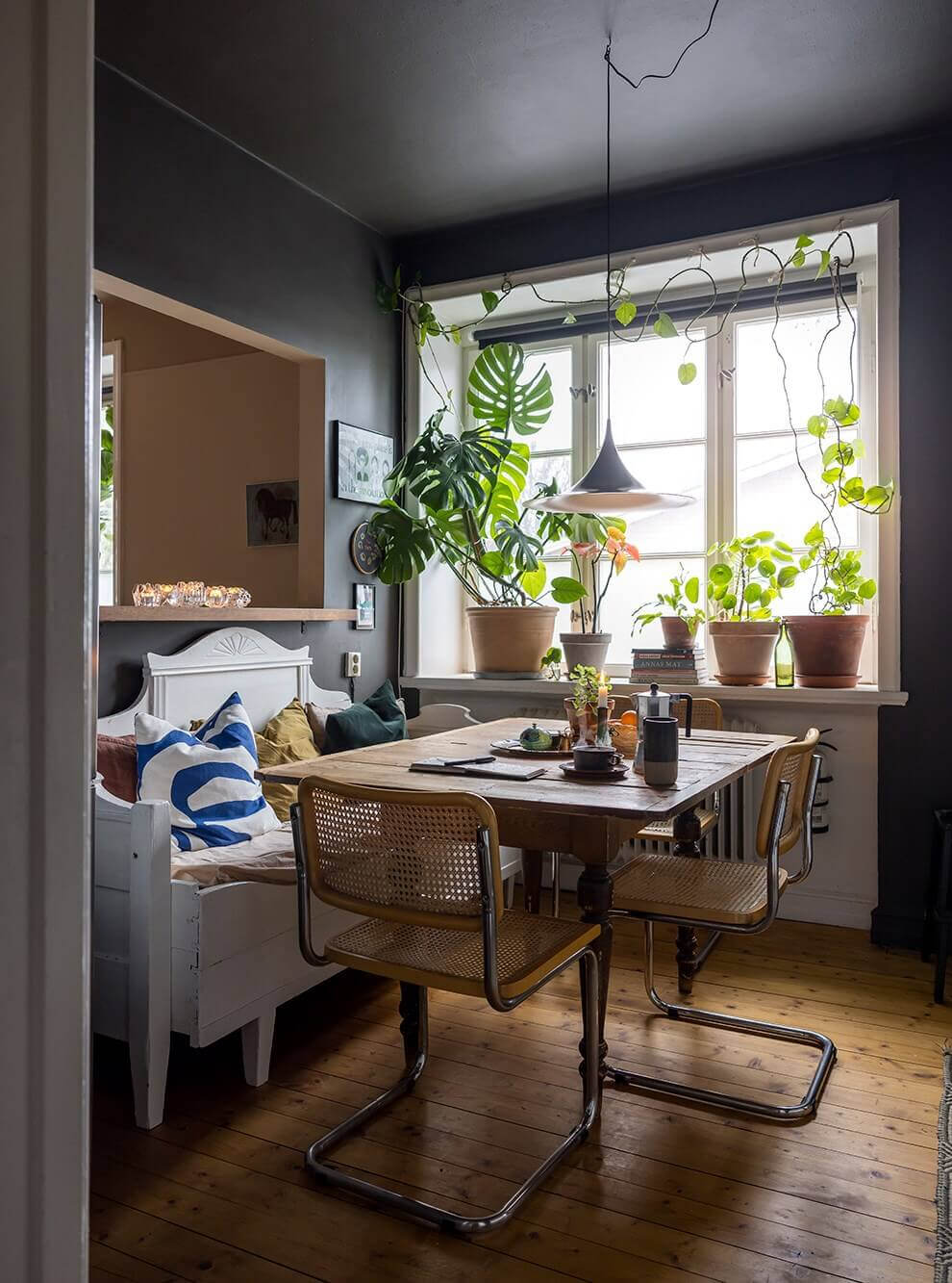kitchen dining table with white bench and wooden floorboards