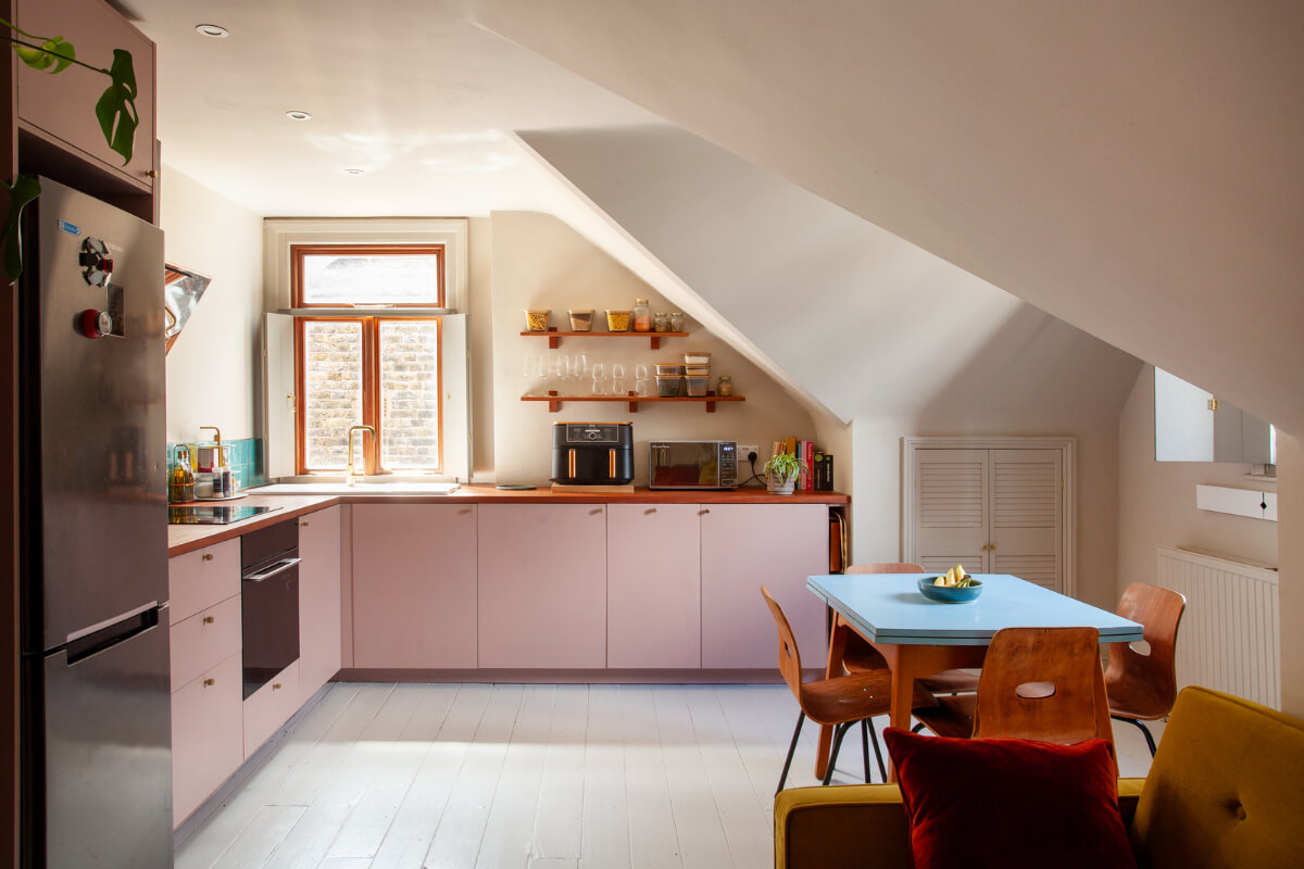 Pastel Tones and Midcentury Design in a Top Floor London Apartment 1 kitchen pink cabinets blue dining table