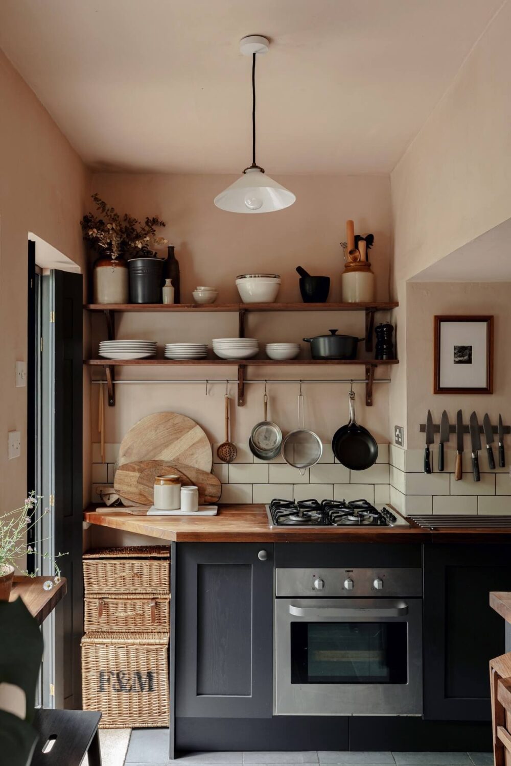 The Pros and Cons of a Wooden Kitchen Countertop 23 kitchen-pink-walls-dark-gray-cabinets-open-shelves-period-home-london-nordroom