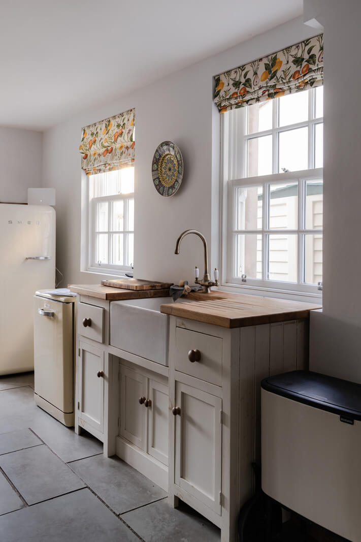 A Georgian English House Restored To Its Former Glory 6 kitchen with stone floor white cabinets wooden worktop