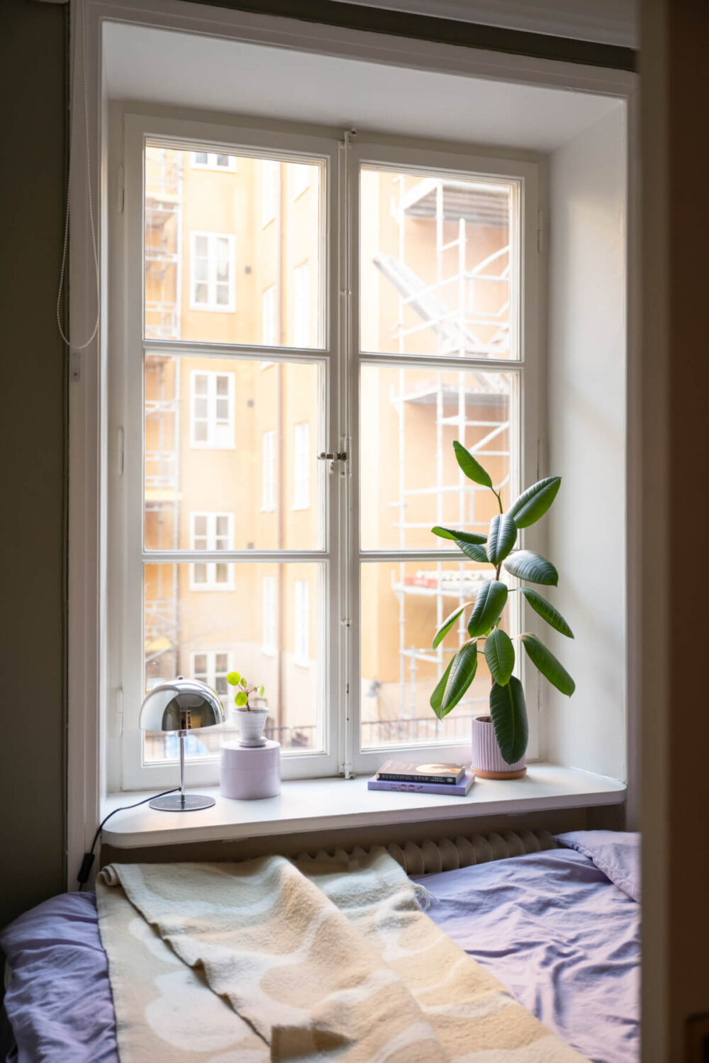 A Small Swedish Apartment with a Light Pink Living Room 15 large bedroom window