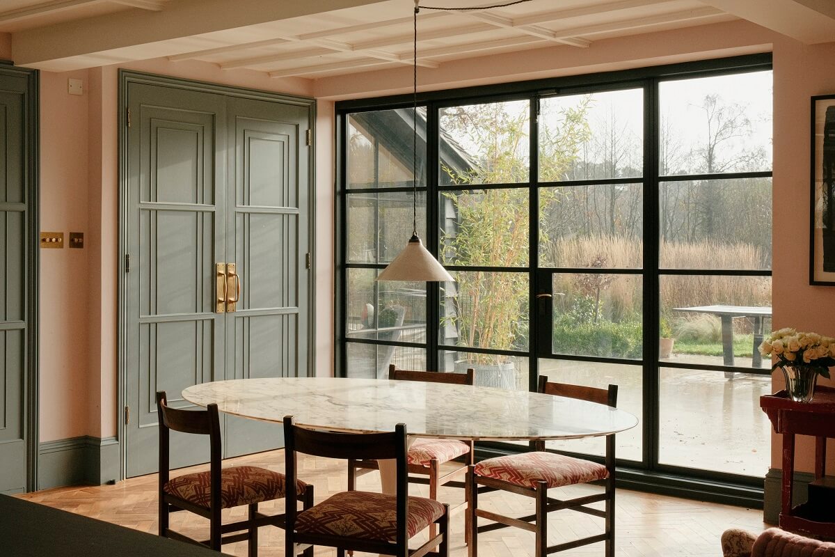 A Barn House with Vintage Decor and Exposed Beams 13 large crittal windows and dining table