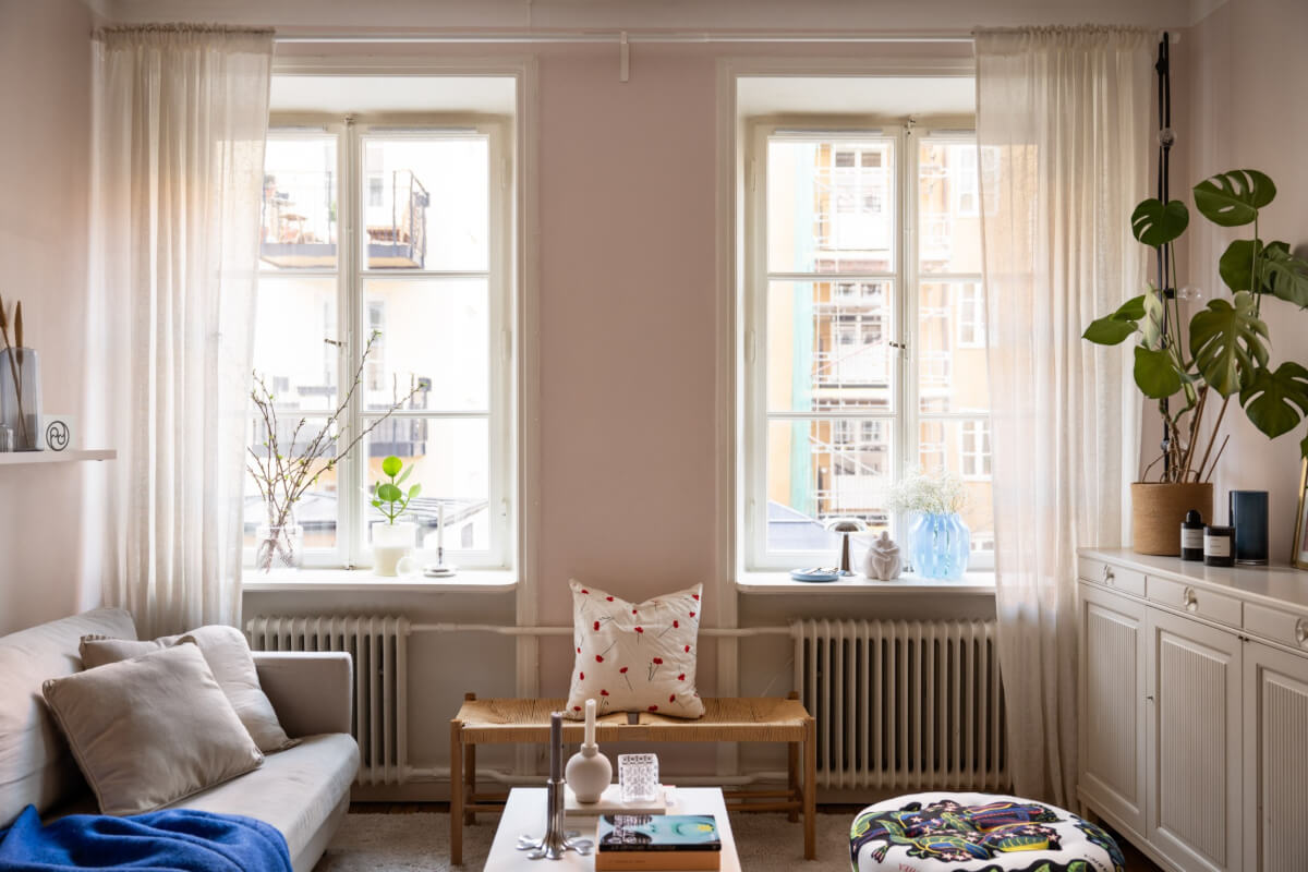 A Small Swedish Apartment with a Light Pink Living Room 2 large original windows