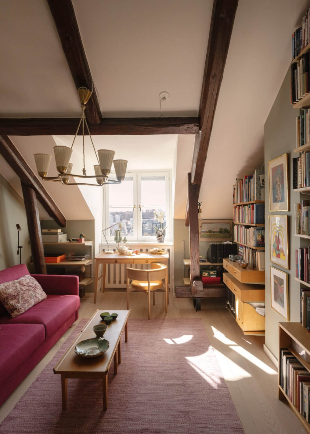 Revisiting a Spectacular Stockholm Penthouse with Exposed Beams 18 library room desk under window