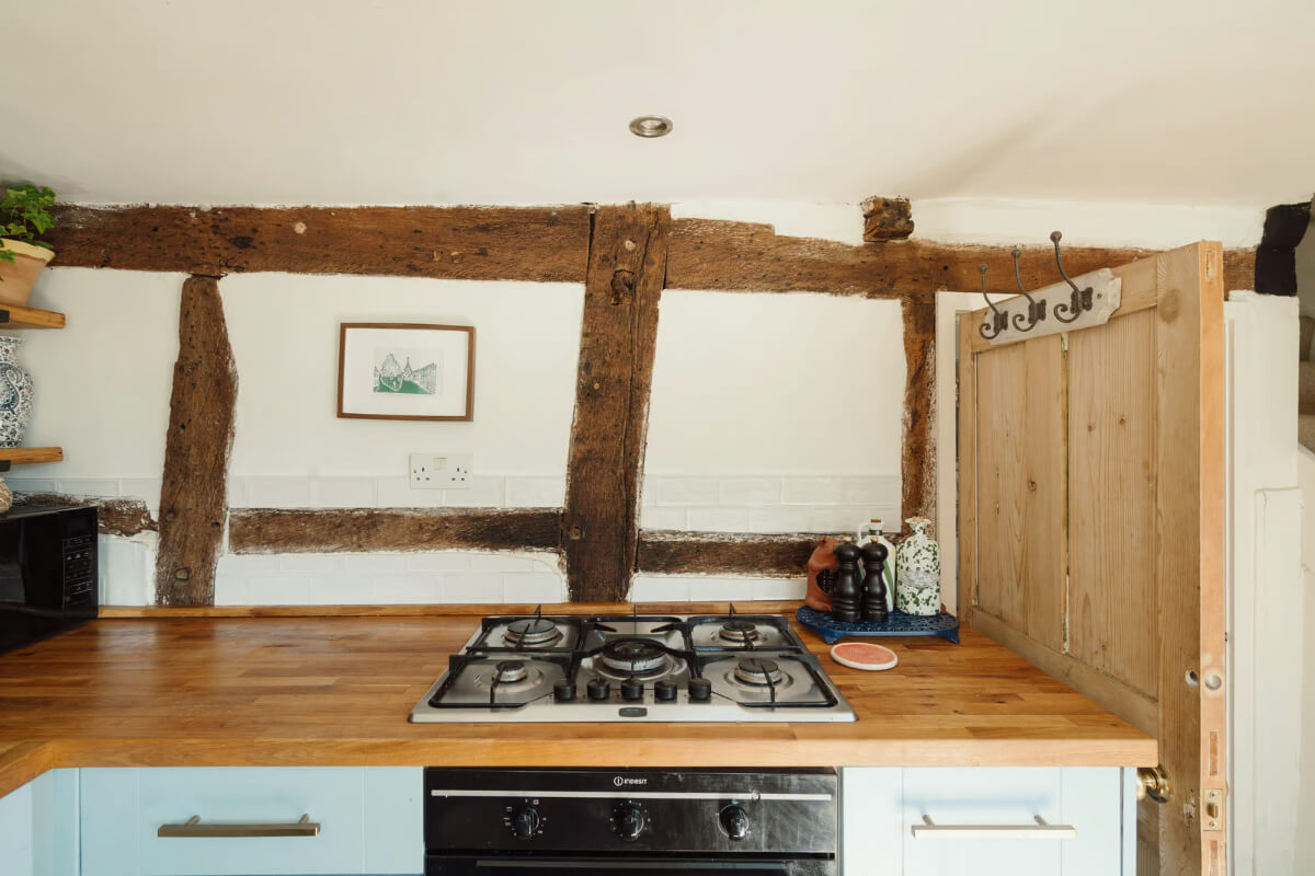 A Historic English Cottage Decorated in Pink & Blue Tones 7 light blue cottage kitchen timber beams
