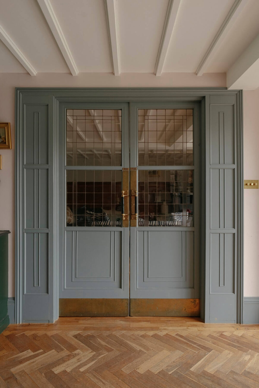 A Barn House with Vintage Decor and Exposed Beams 15 light blue glass and wood sliding doors with brass features