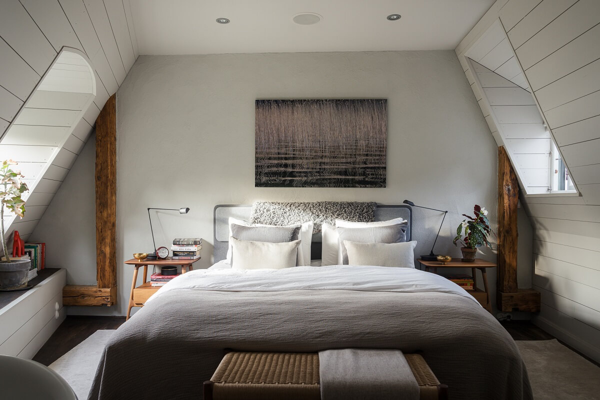 A Stylish Penthouse Apartment with Exposed Beams 20 light gray bedroom slanted ceilings wooden beams