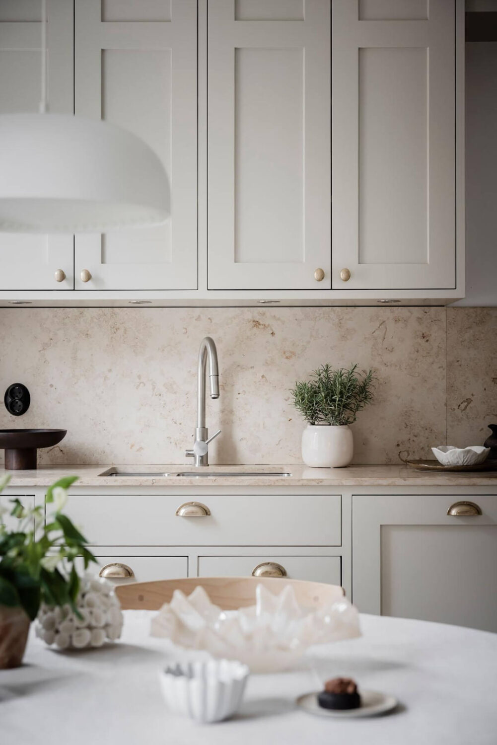 A Light Corner Apartment with an Open Flowing Floor Plan 4 light gray kitchen cabinets