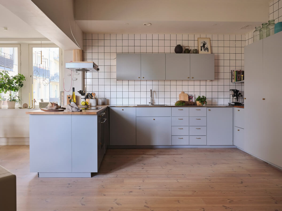 A Bright Family Apartment in a 1950s School Building 6 light gray kitchen square white backsplash tiles