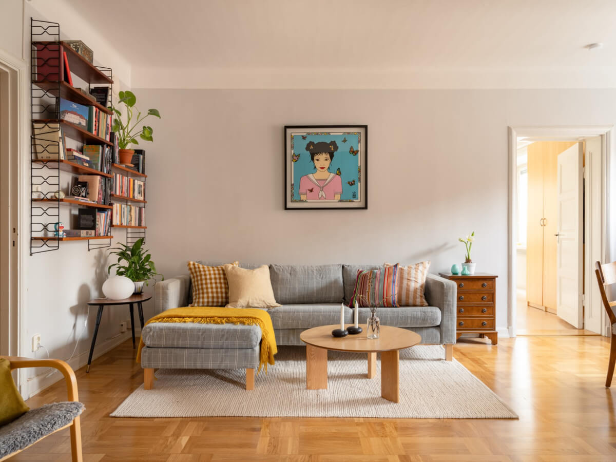 A Light Corner Apartment with a Pale Yellow Kitchen 2 light gray walls living room