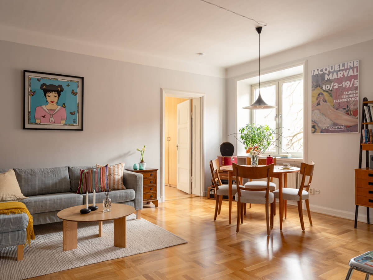 A Light Corner Apartment with a Pale Yellow Kitchen 1 light living room round table