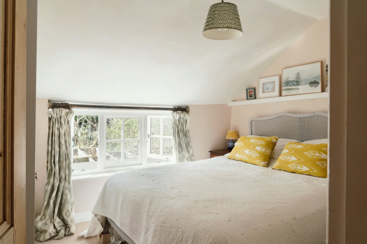 A Historic English Cottage Decorated in Pink & Blue Tones 13 light pink walls cottage bedroom low window