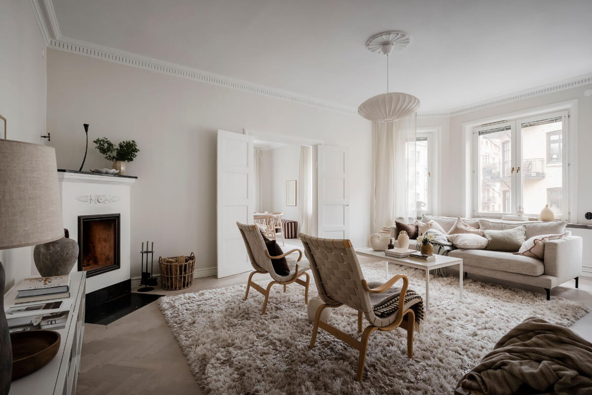 A Light Corner Apartment with an Open Flowing Floor Plan 15 light swedish living room large rug fireplace