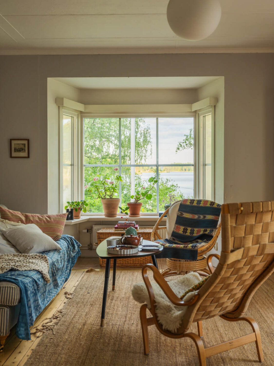 A 1930s Lakeside Country House with a Private Beach 19 living room bay window lake view