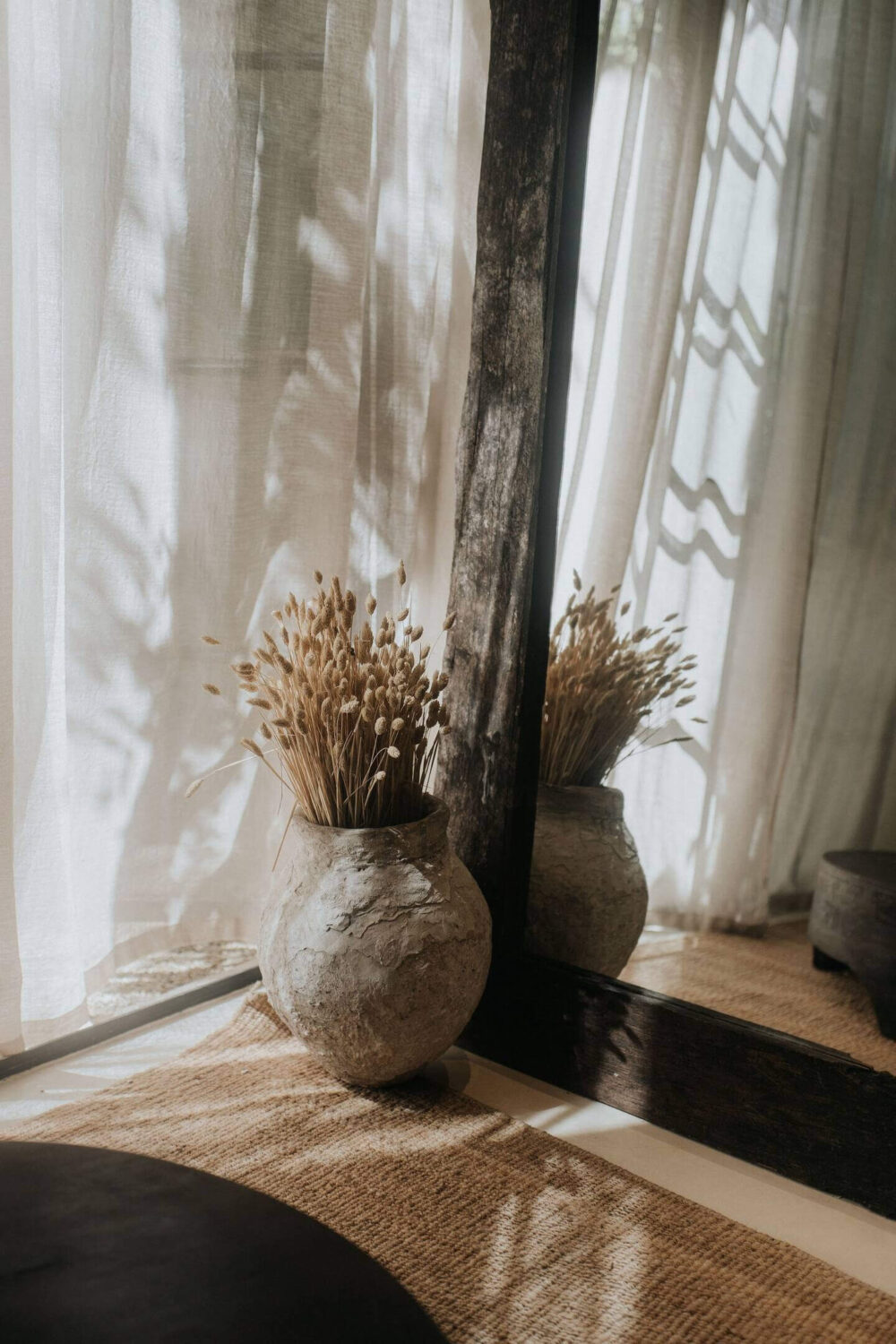 Rustic Wooden Elements in a Stylish Tulum Airbnb 9 living-room-detail-large-wooden-mirror-stone-vase-nordroom