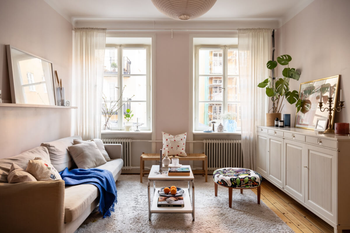 A Small Swedish Apartment with a Light Pink Living Room 1 living room large window light pink walls