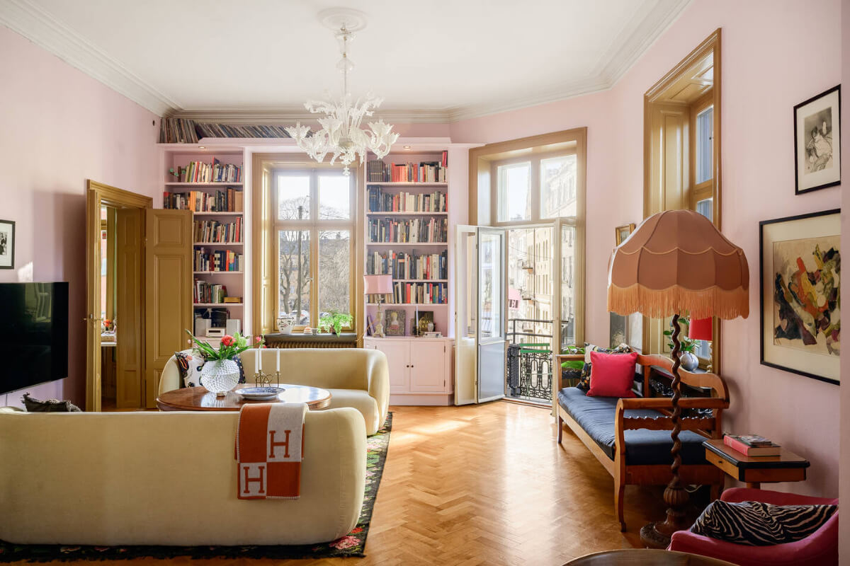 A Pink Living Room in a Light-Filled Stockholm Apartment 1 living room pink walls bookcases