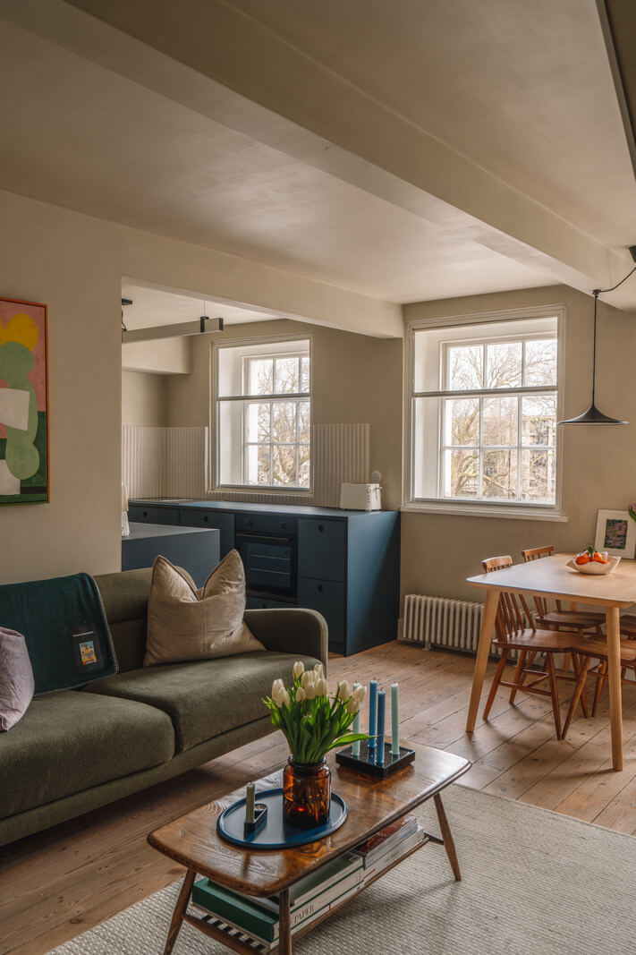 living room plaster walls wooden floorboards blue kitchen