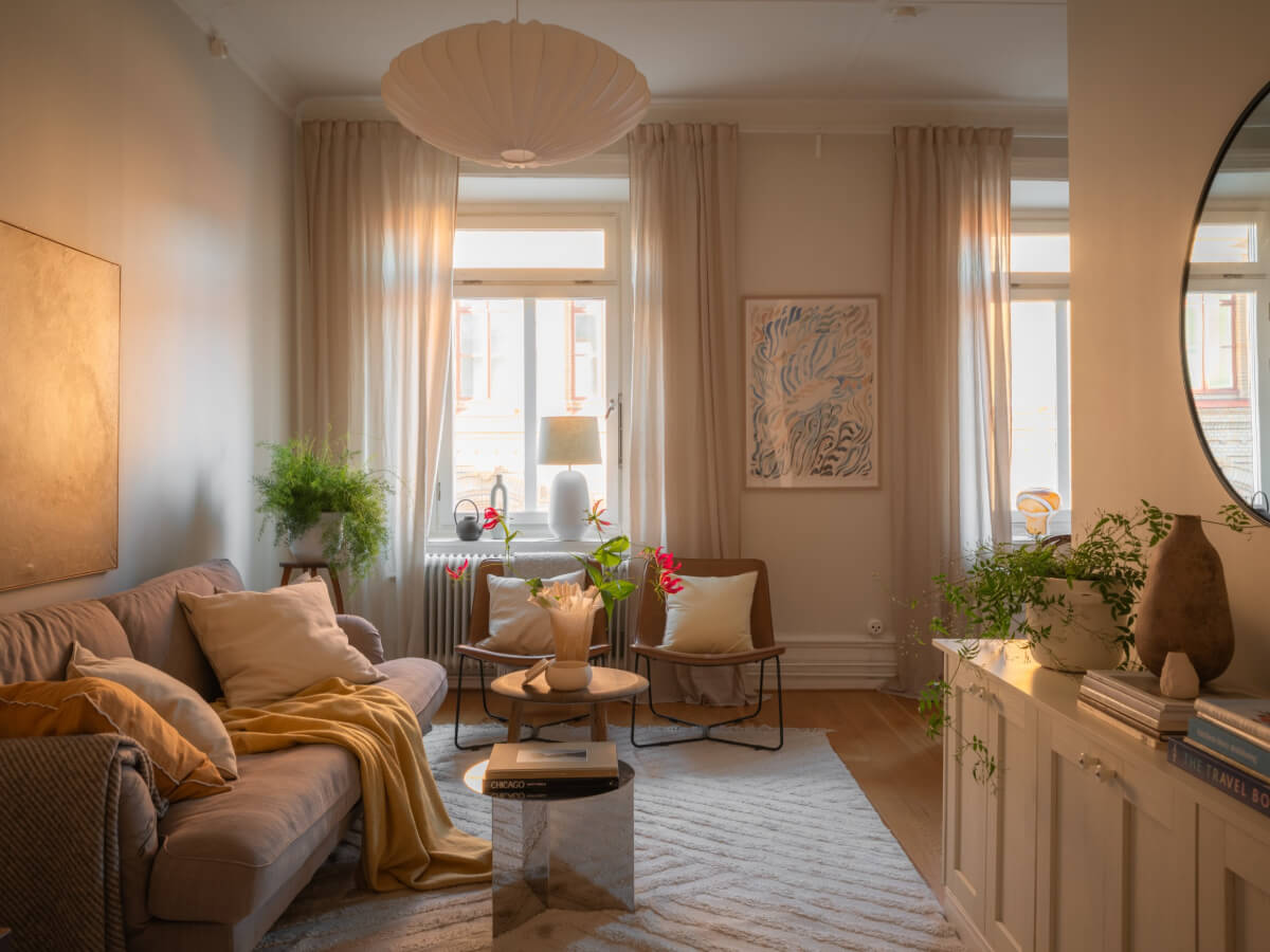 A 19th Century Apartment with a Dark Glass Room Divider 1 living room warm natural light