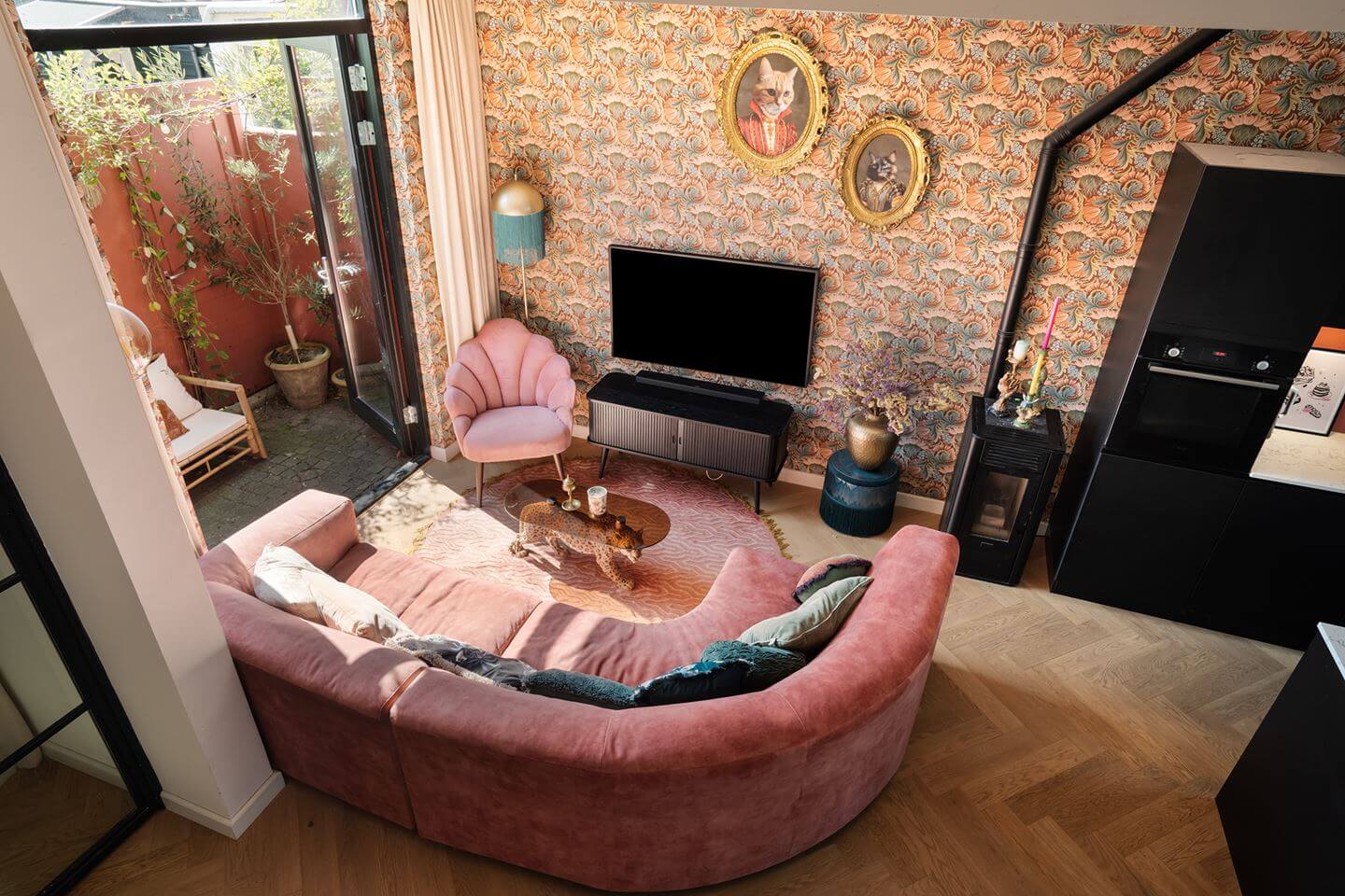 living room with pink curved sofa wallpapered walls nordroom