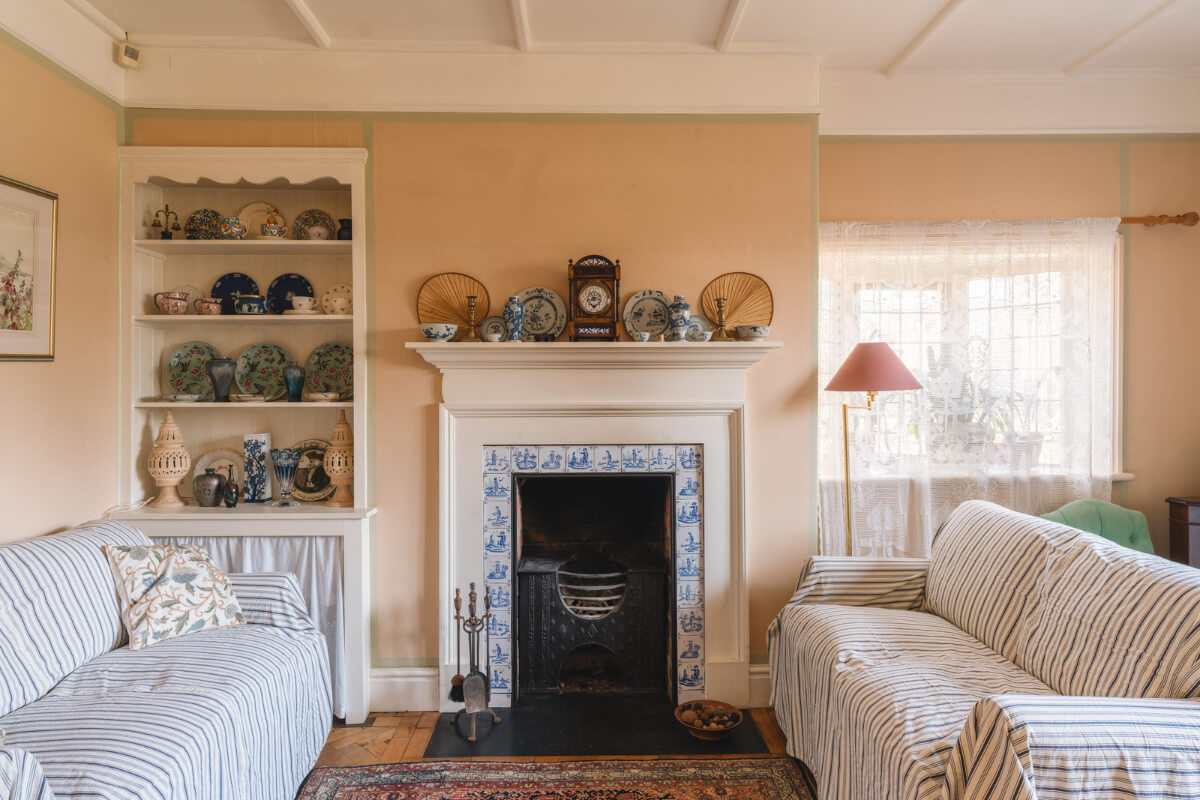 A Sage Green Kitchen in a Charming Arts and Crafts House 1 living room yellow-beige walls green border fireplace
