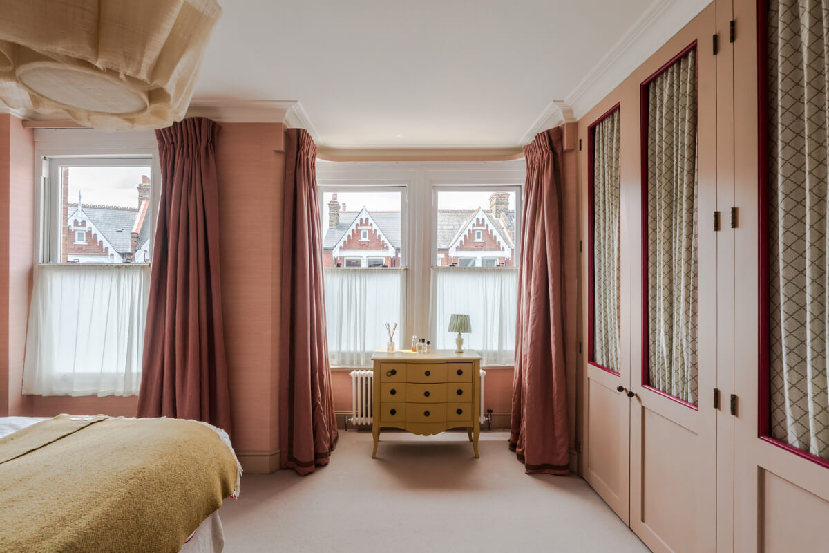 Color, Pattern, and Texture in a Renovated London Townhouse 13 master bedroom pink wallpaper built-in wardrobes with curtains