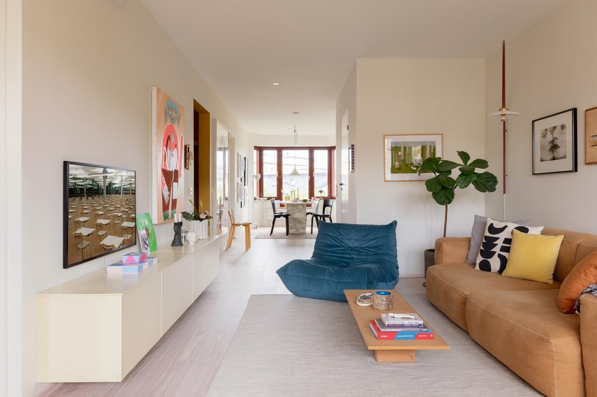 The Color Trends for 2025: Warm, Natural Shades and a Cheerful Accent 70 modern open plan living room with blue ligne roset togo chair