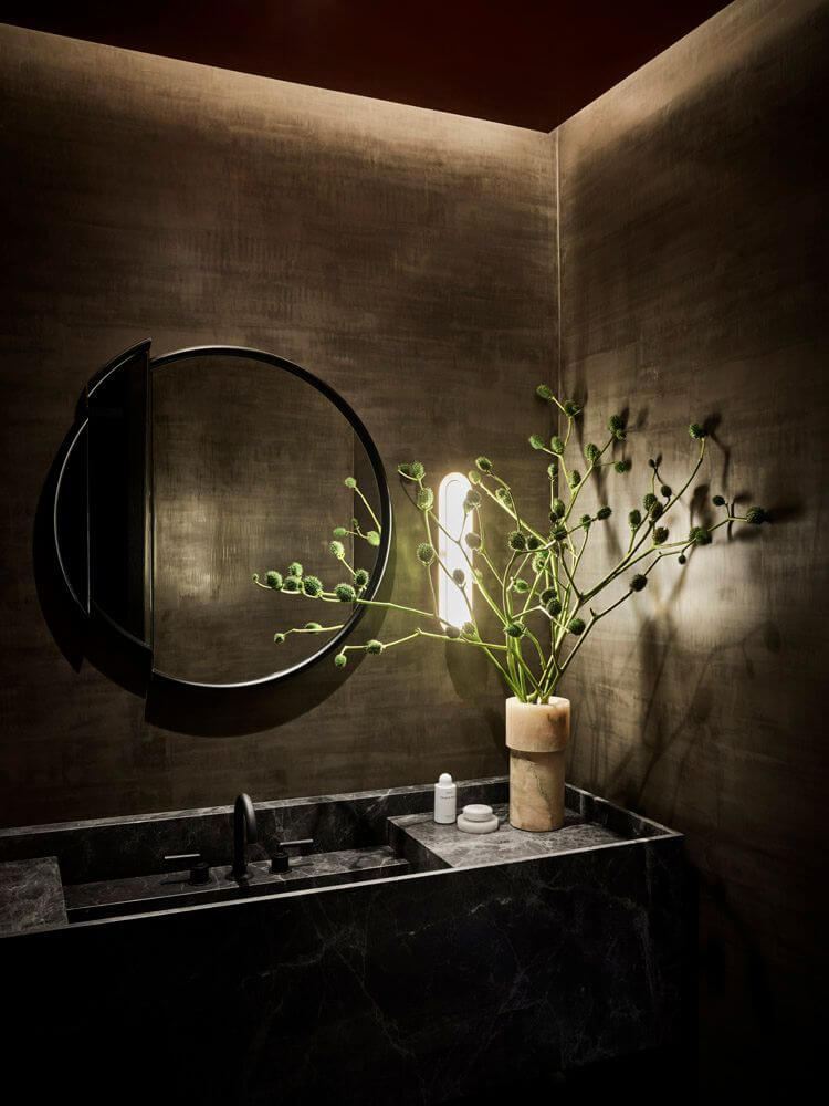 Moody, not Gloomy! Beautiful Dark Small Bathrooms 23 moody powder room round mirror penthouse trevor noah nordroom Moody, not Gloomy! Beautiful Dark Small Bathrooms