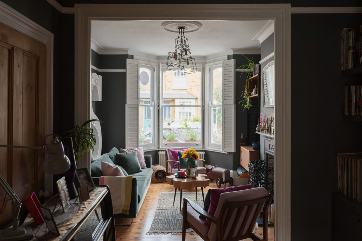 Exposed Brick and Wooden Beams in an Extended London Home 1 moody sitting room wooden floor bay window