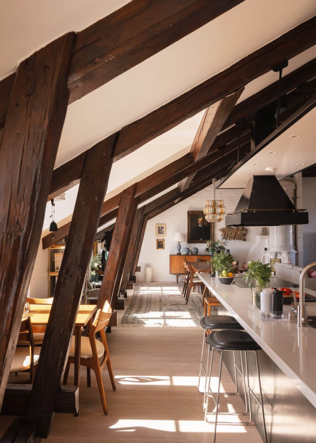 Revisiting a Spectacular Stockholm Penthouse with Exposed Beams 13 natural light kitchen bar seating