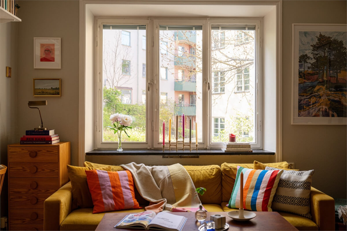 Midcentury Design and Colorful Decor in a Charming Studio Apartment 7 ochre sofa colorful cushions