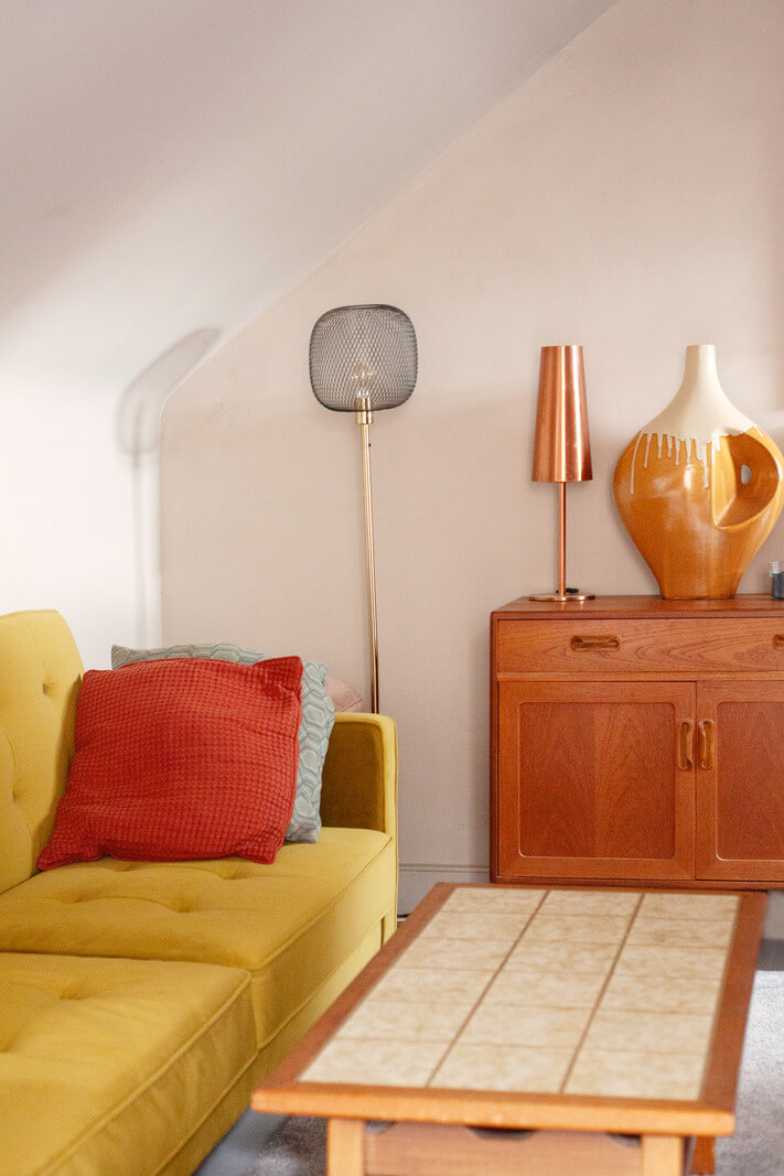 Pastel Tones and Midcentury Design in a Top Floor London Apartment 11 ochre sofa detail