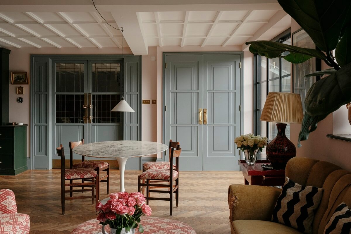 A Barn House with Vintage Decor and Exposed Beams 5 open plan kitchen sitting room with wooden doors