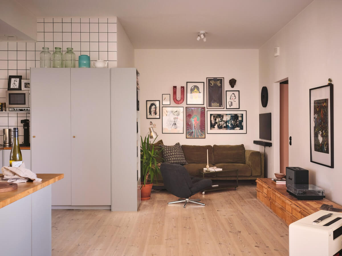 A Bright Family Apartment in a 1950s School Building 1 open-plan living room green sofa white walls